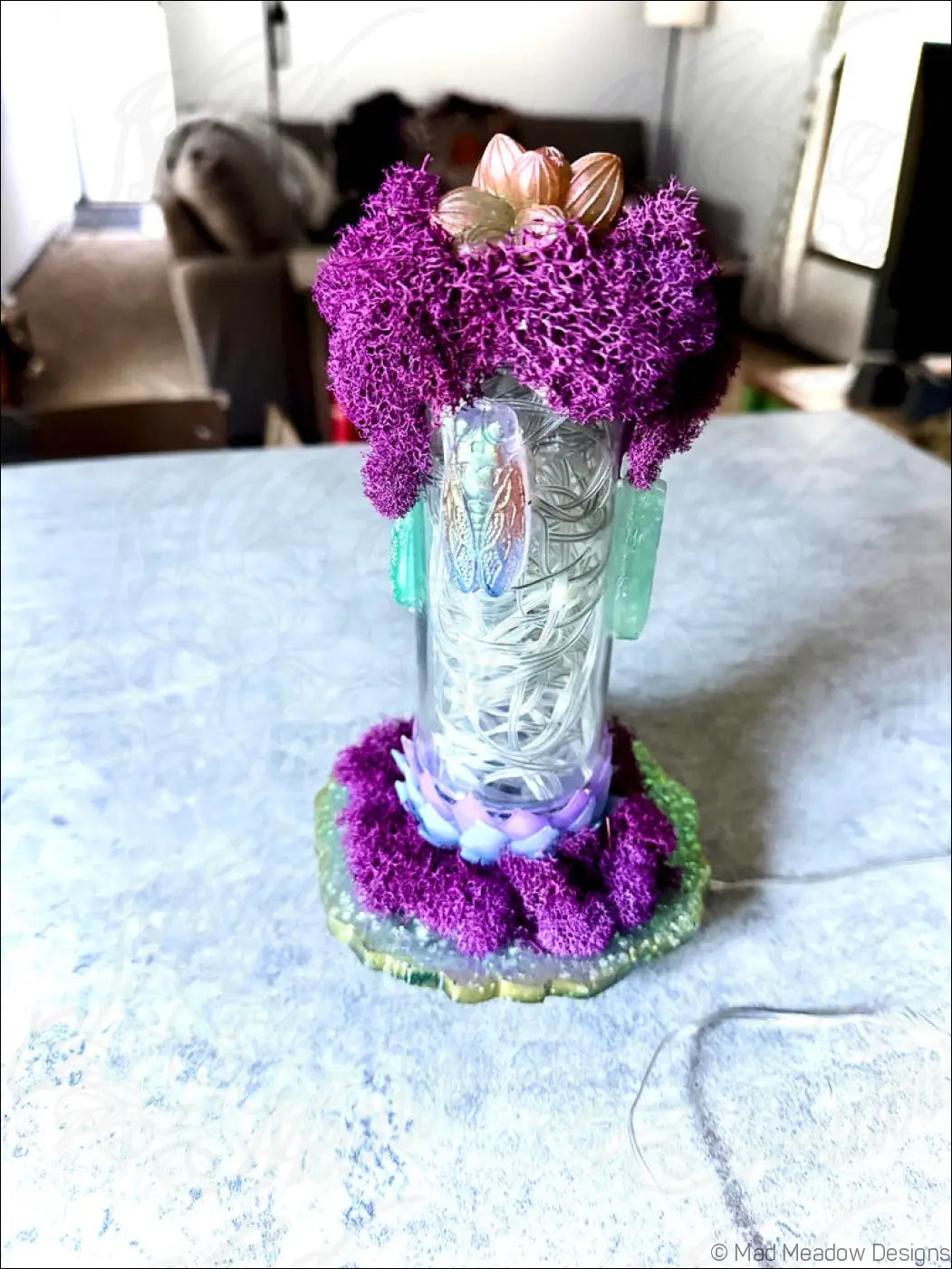 A translucent vintage glass vase with silver filigree, purple moss, teal resin, featuring resin cicadas with white usb light