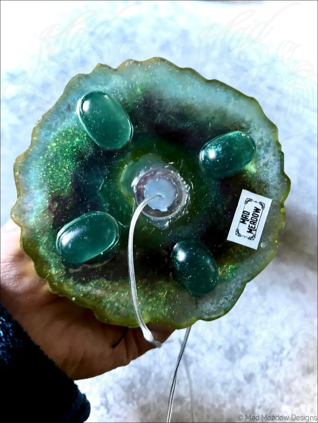 A green resin cicadas lamp base with teal stones and a glass bulb holder for a white usb vintage light