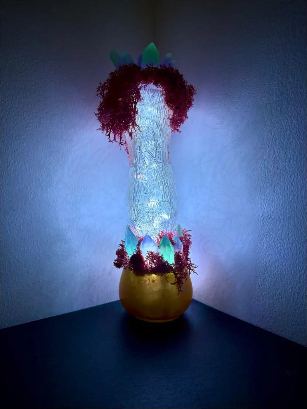 A glowing jellyfish-shaped resin lamp with red coral accents and a golden base in a whistle soda vintage style