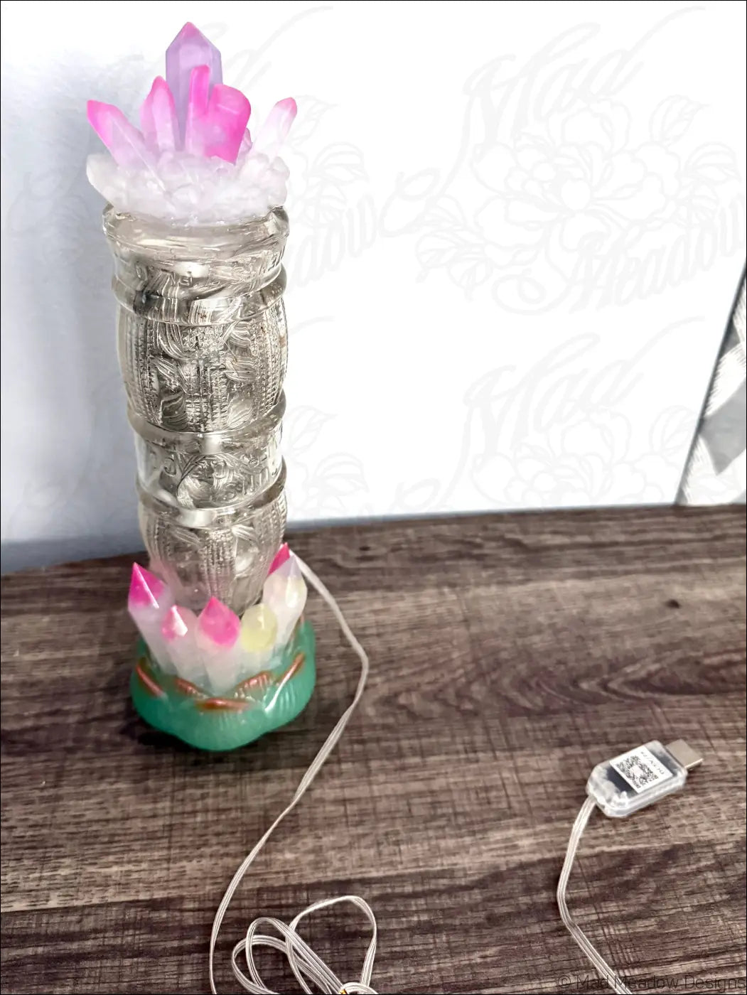 Translucent glass lamp with engraved patterns, pink resin crystals, and green base inspired by 1940s sunset beverage design