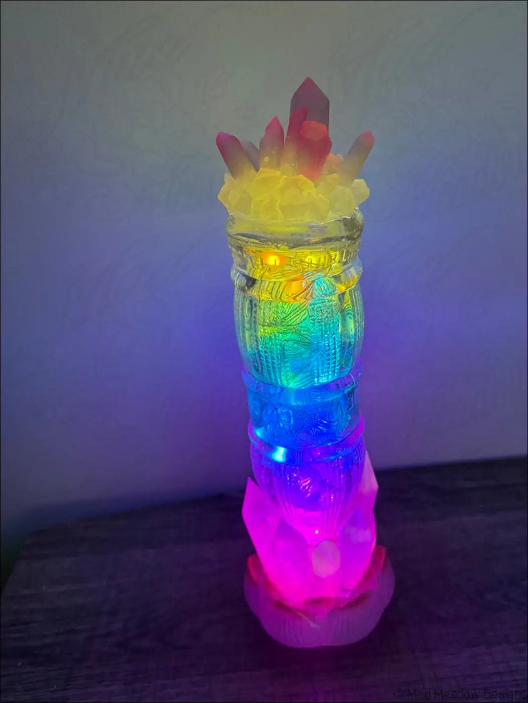 A vibrant multi-colored led crystal tiki torch lamp with translucent glass and glowing rainbow lights for 1940s sunset beverage vibes