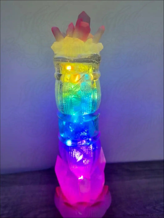 A vibrant multi-colored led tiki torch with a translucent body glowing with 1940s sunset beverage themed lights