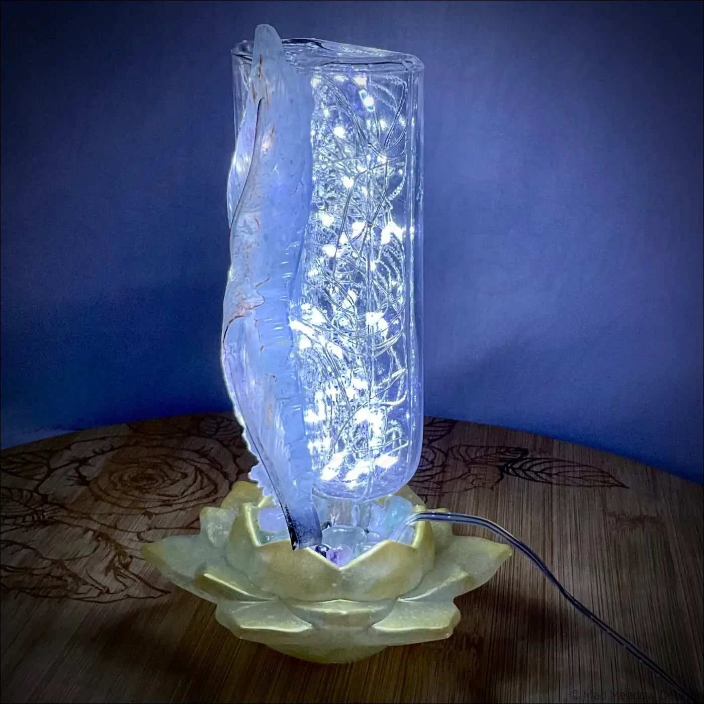 A translucent glass apothecary bottle with intricate led design on a golden lotus base antique glass apothecary light
