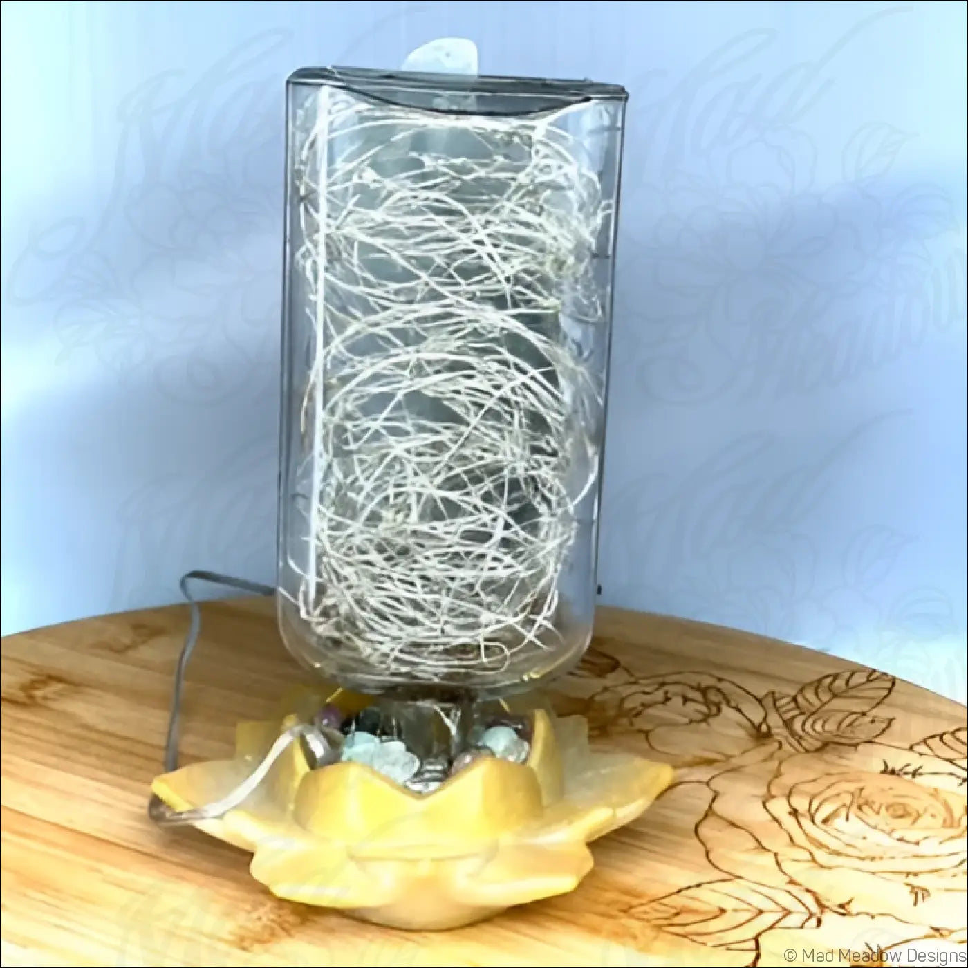 Clear glass antique apothecary bottle lamp with silver wire design on yellow lotus flower usb light base