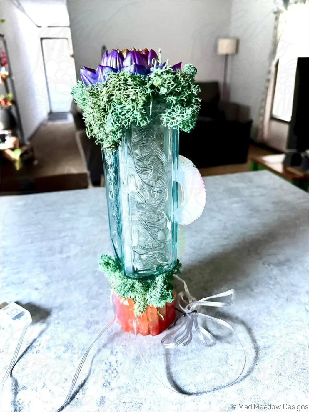 Turquoise glass cactus-shaped usb lamp with purple flowers green moss and white circular handle from snake and lotus