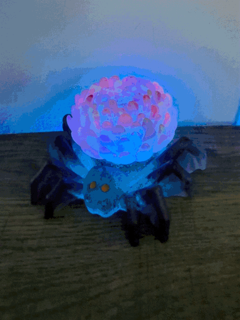 Glowing blue and pink spider-shaped led lamp with translucent textured body usb app controlled spider flower light