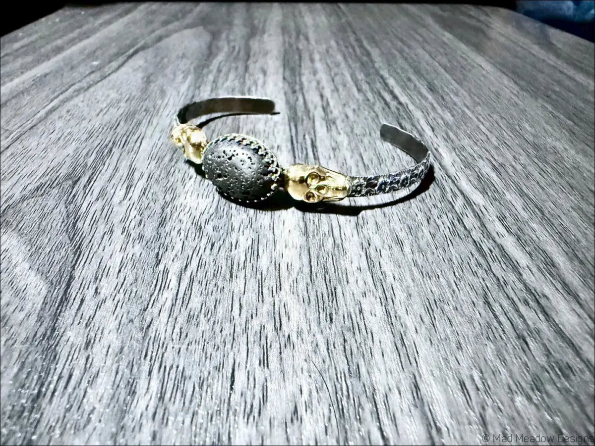 Sterling Silver Cuff Bracelet with Brass Skulls and Lava Stone - Bracelet