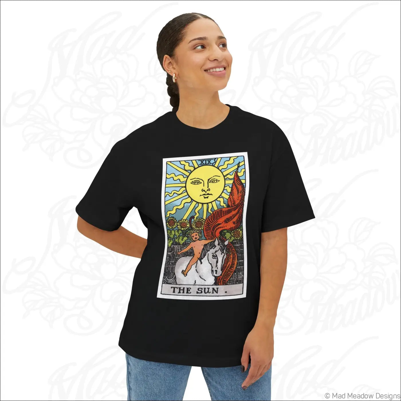 Black oversized boxy tee featuring colorful sun tarot card graphic with yellow sun face red wings and white horse designed for low heat care