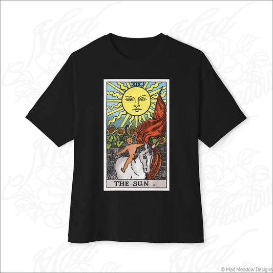 Black oversized boxy tee featuring colorful sun tarot card graphic with smiling sun, child on white horse, and red flames, low heat care