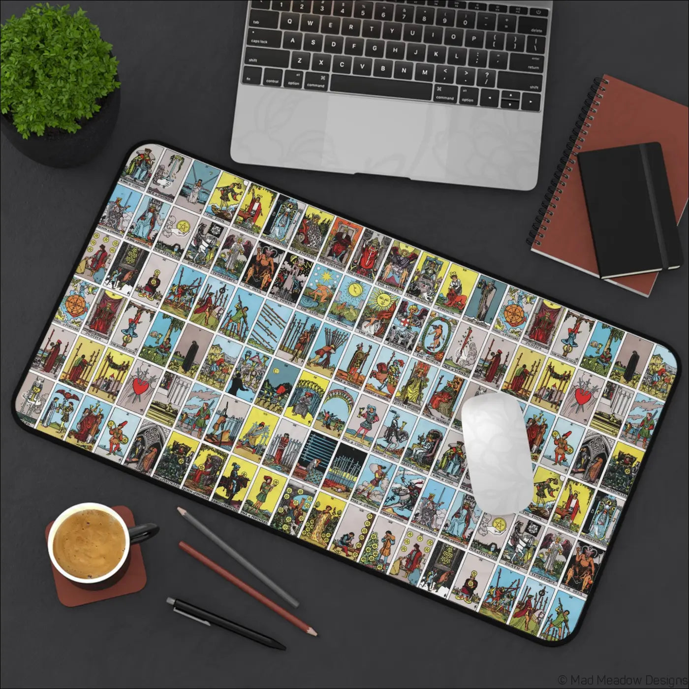 Rectangular desk mat featuring a vibrant vintage lotería-style tarot card grid in yellow blue and red with care instructions for warm water cleaning