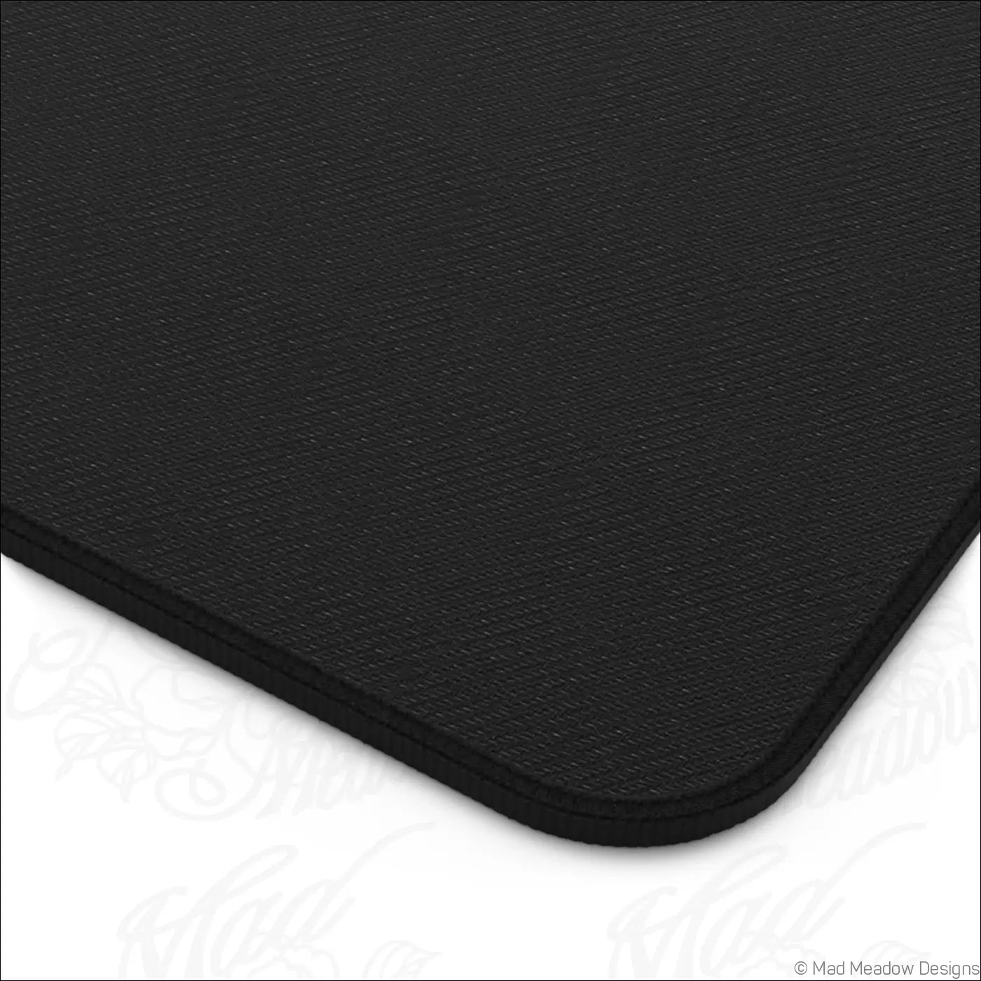 Black textured desk mat with subtle woven pattern and rounded edges care instructions recommend warm water cleaning