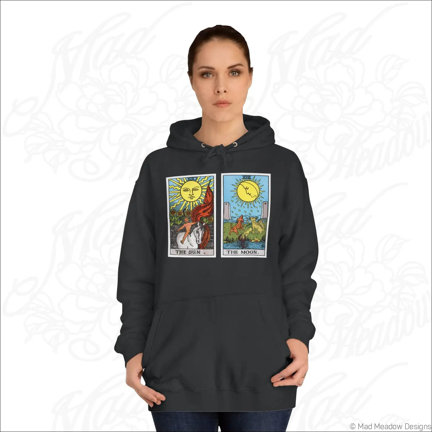 Black hoodie with vibrant tarot card print of the sun and the moon featuring care instructions for low heat wash