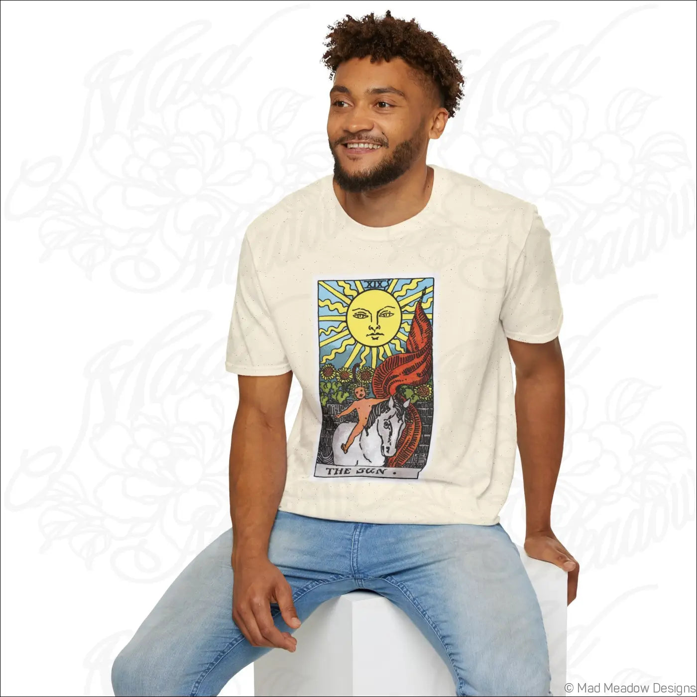 Cream-colored cotton t-shirt with vintage tarot sun card design featuring bold yellow sun and red dragon motifs made from ethically sourced cotton