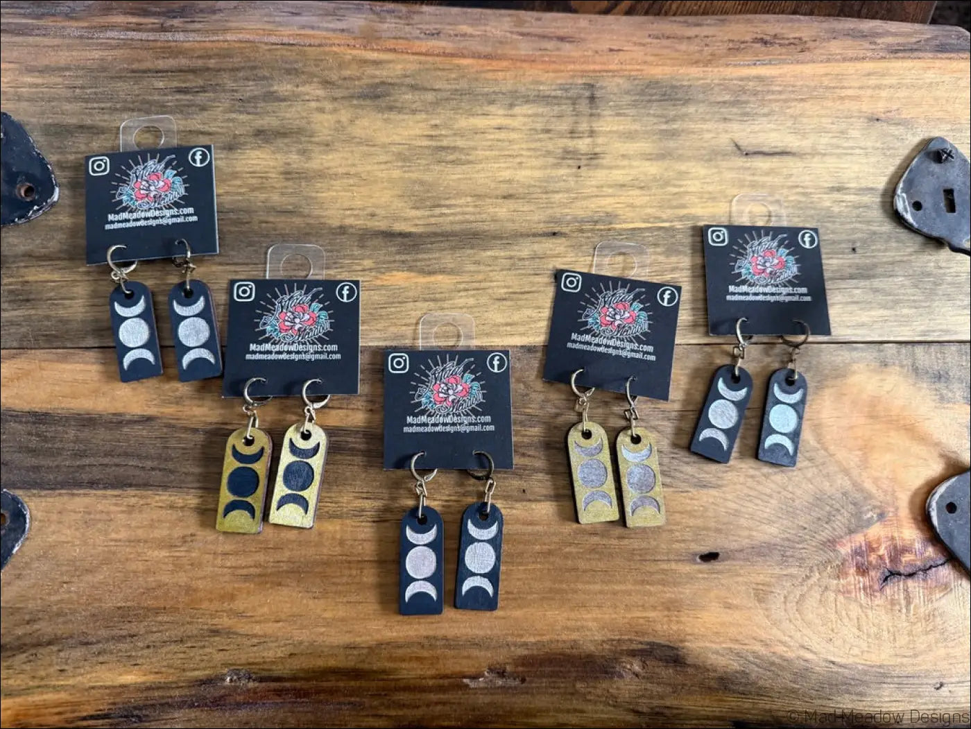 Black and gold triple moon wooden earrings with minimalist engraved lunar phases on rectangular metal tags