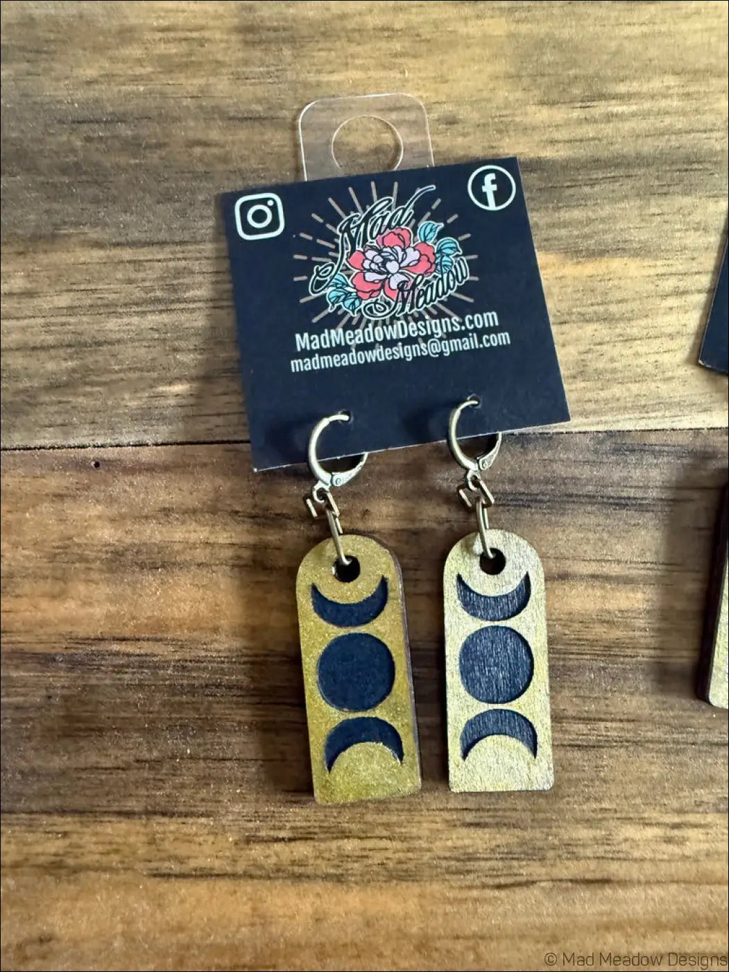 Triple moon wooden earrings with gold finish and deep blue laser-cut moon phases hand-painted design