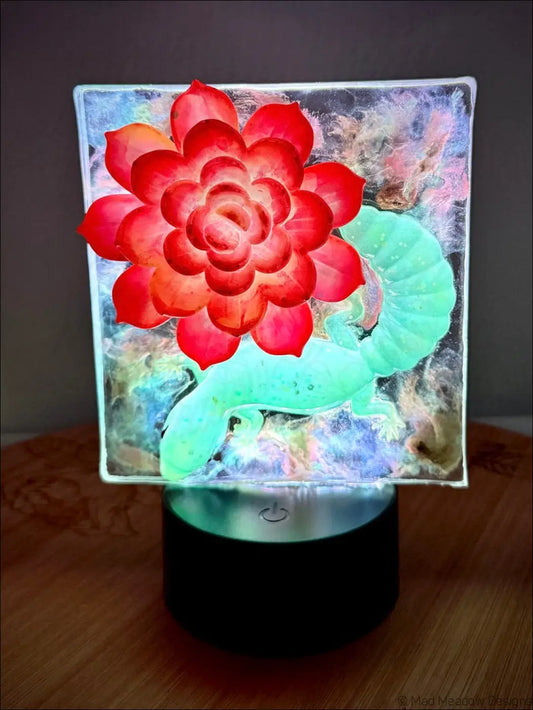 Whimsical glowing gecko glass lamp with vibrant crimson bloom and warm golden RGB color change night light design